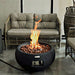 Modeno York Black Concrete Fire Bowl on Patio with Flame