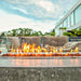 Elementi 55 Inch Hampton Rectangular Concrete Fire Table in Light Gray On Patio with Wind Guard