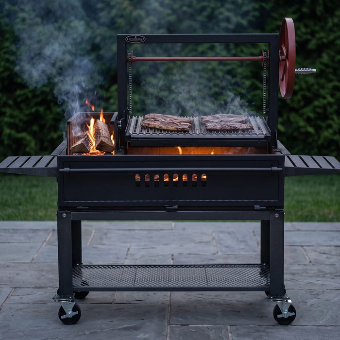 Sunterra side brasero gaucho grill cooking over oak embers on a stone patio