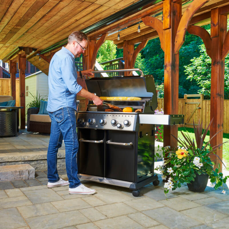 Broil King Baron 590 PRO Black 5-Burner Gas Grill | Shown Grilling on Patio