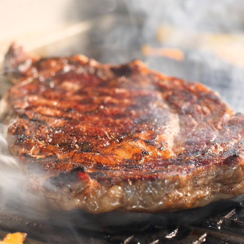 Coyote 18-Inch Electric Grill on Patio Post | Grilling Steak