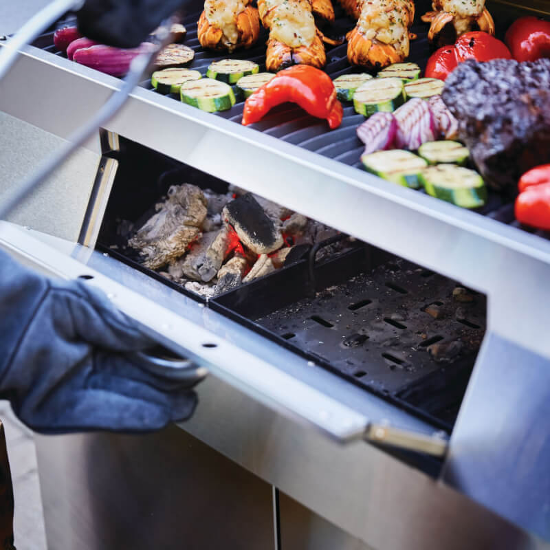 Napoleon Professional Freestanding Charcoal Grill | Shown Loading Charcoal Tray