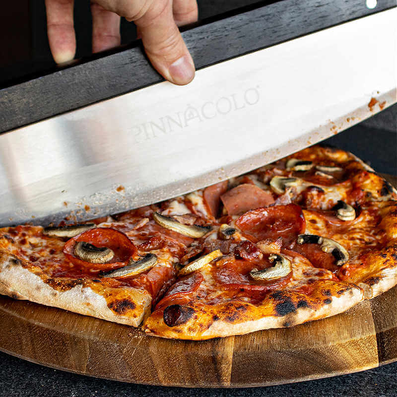 Pinnacolo 14-Inch Stainless Steel Rocker Cutter | close Up Cutting Pizza
