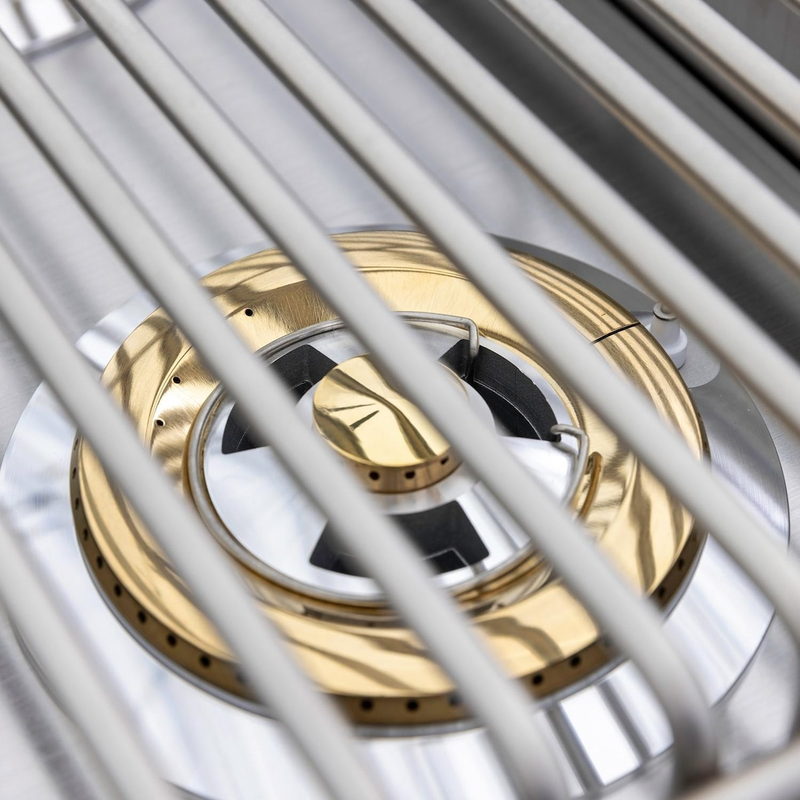 Blaze LTE+ brass burner detail beneath stainless steel cooking grates