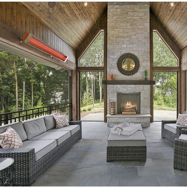 Bromic Cobalt electric heater mounted under the roof of a covered patio with a stone fireplace
