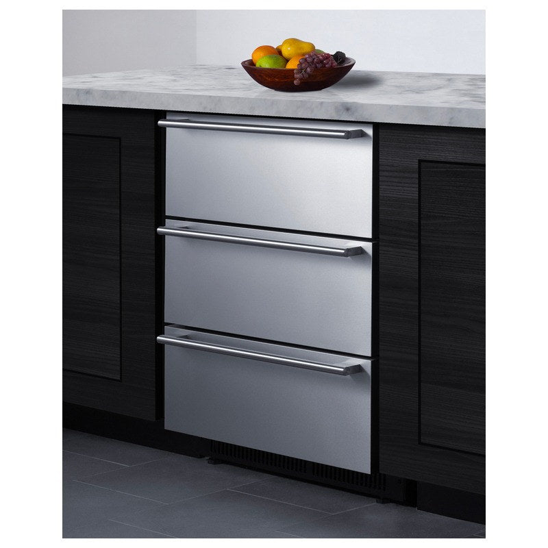 Summit SP6DS3DOS 3-drawer refrigerator built into dark cabinetry beneath a marble countertop