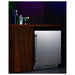 Summit SPR7BOSSTSR 24-inch outdoor all-stainless refrigerator with speed rail, installed in outdoor bar with speed rail, lifestyle view
