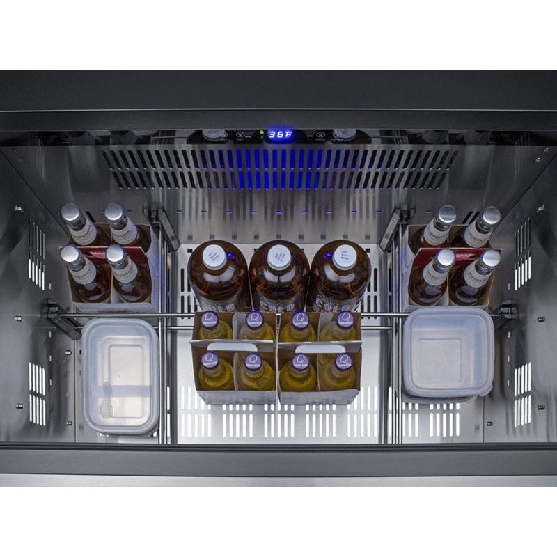 Summit SPR36DROS outdoor refrigerator drawer open and stocked with bottles and food containers.