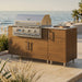 WeatherStrong 68 inch Horizon outdoor kitchen island Miami Teak on a coastal patio