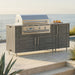 WeatherStrong 68 inch Horizon outdoor kitchen island Sanibel Dark Ash on a coastal patio
