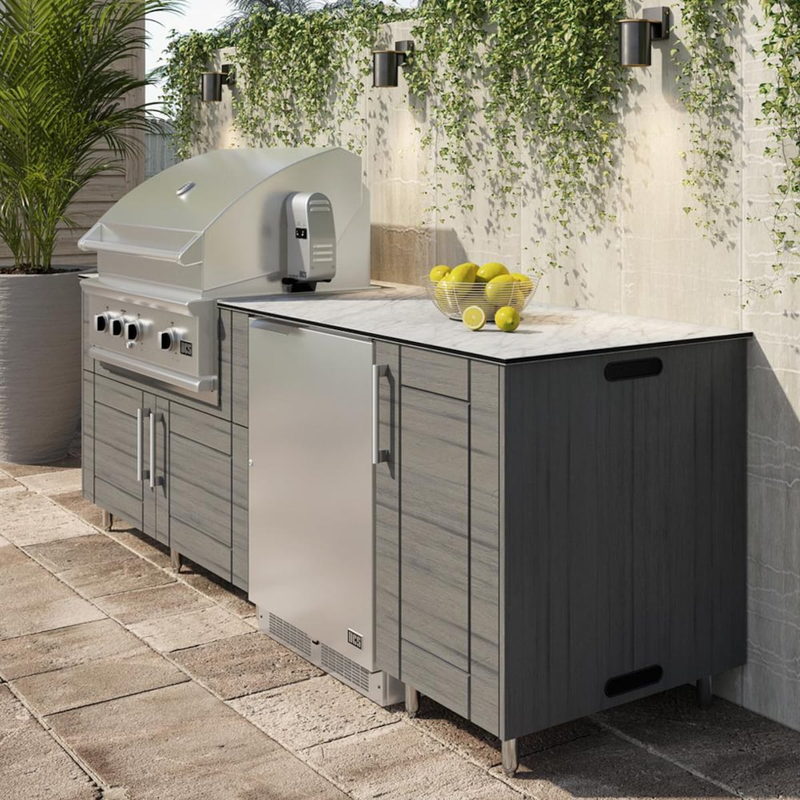 WeatherStrong Bimini Dark Ash outdoor kitchen island with Blaze grill and refrigerator on a covered patio