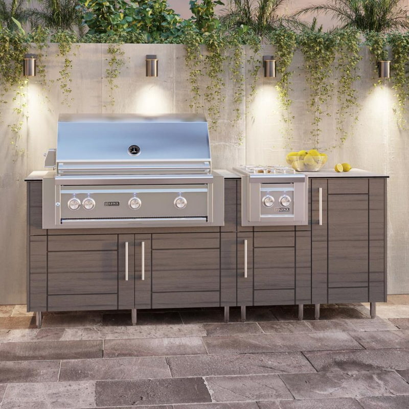 WeatherStrong Abaco Dark Ash outdoor kitchen island with Blaze grill and side burner on a patio