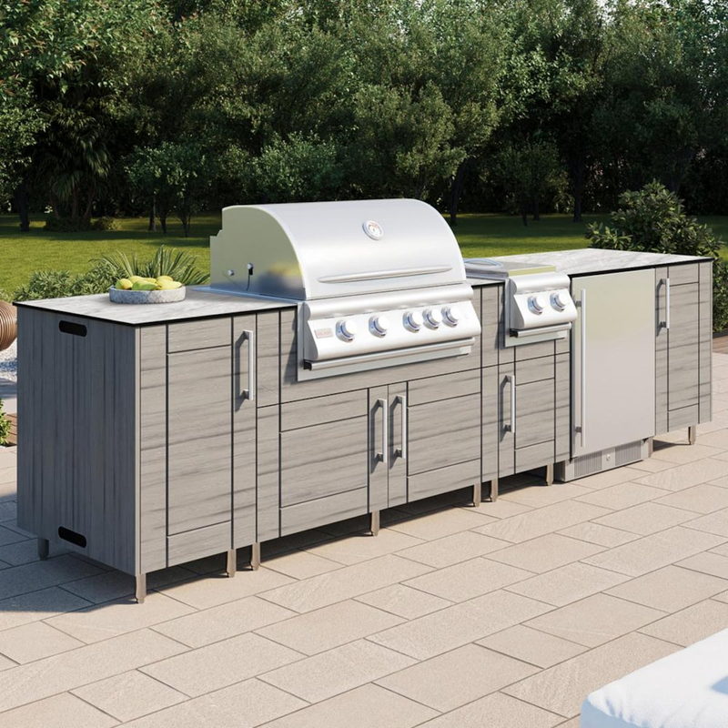 WeatherStrong Nassau Dark Ash outdoor kitchen island with Blaze grill, side burner and refrigerator in a backyard
