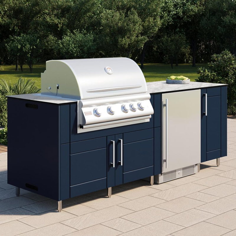 Angled view of WeatherStrong Bimini Sapphire Blue outdoor kitchen island with Blaze grill and refrigerator