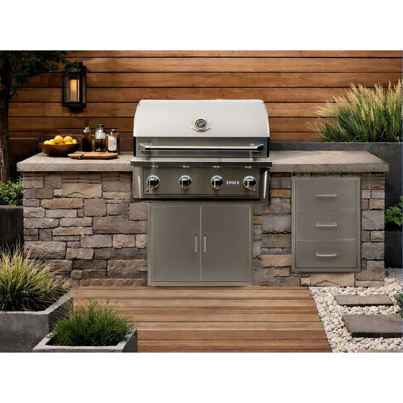 Wildfire Ember 32-inch stainless steel gas grill built into a stone and wood outdoor kitchen island.
