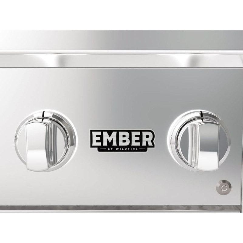 Close-up of the Wildfire Ember gas grill control panel with the Ember by Wildfire badge and a chrome control knob.