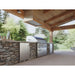 Zephyr Presrv 24-inch outdoor rated beverage cooler built into a stone outdoor kitchen island under a covered patio.