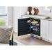 Zephyr Presrv 24-inch beverage cooler installed under a kitchen counter with the glass door open and a serving tray on the pull out shelf.
