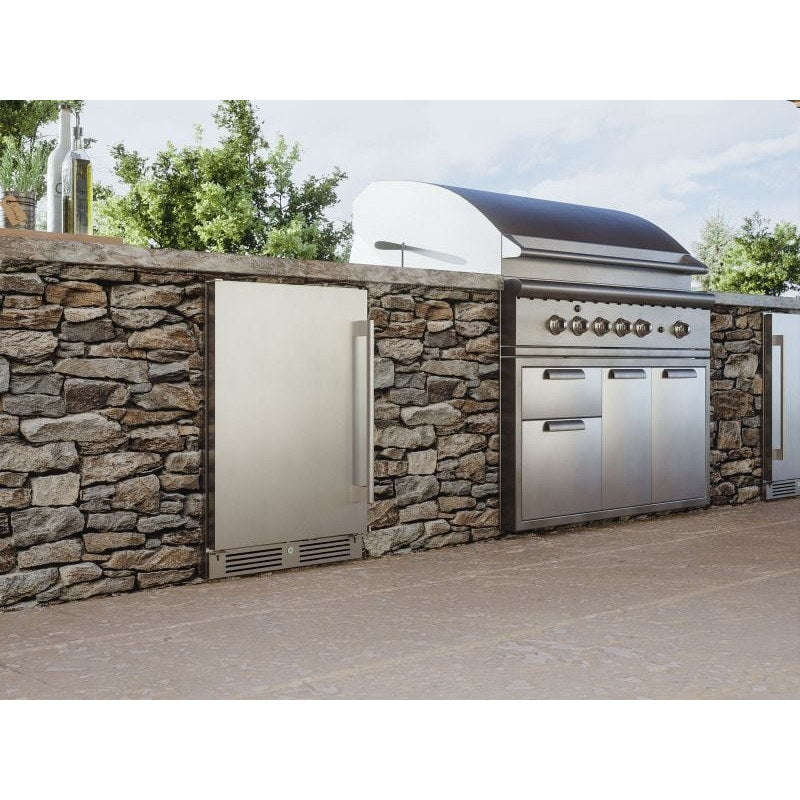 Zephyr Presrv 24-inch outdoor rated beverage cooler built into a stone outdoor kitchen beside a built in gas grill.
