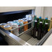 Close-up of a Zephyr Presrv dual drawer refrigerator drawer packed with canned and bottled drinks behind a retaining rail.