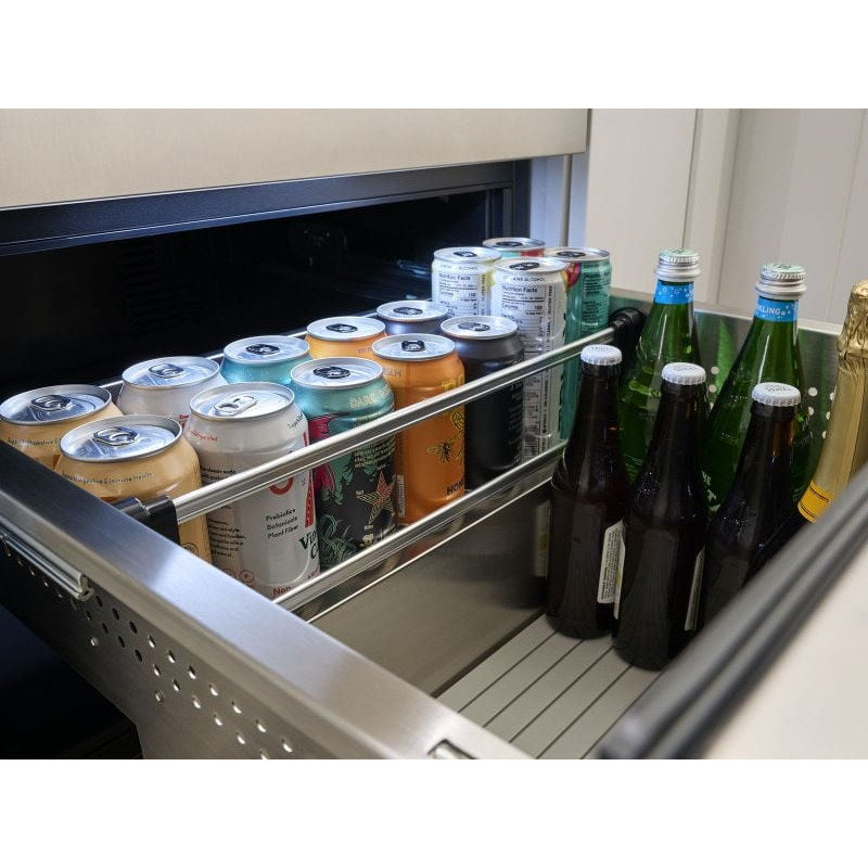 Close-up of a Zephyr Presrv dual drawer refrigerator drawer packed with canned and bottled drinks behind a retaining rail.
