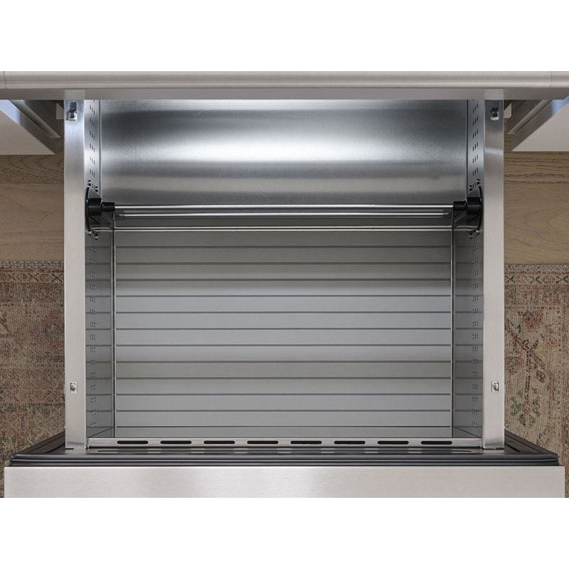 Close-up of the empty ribbed stainless interior and adjustable divider rail inside a Zephyr Presrv refrigerator drawer.